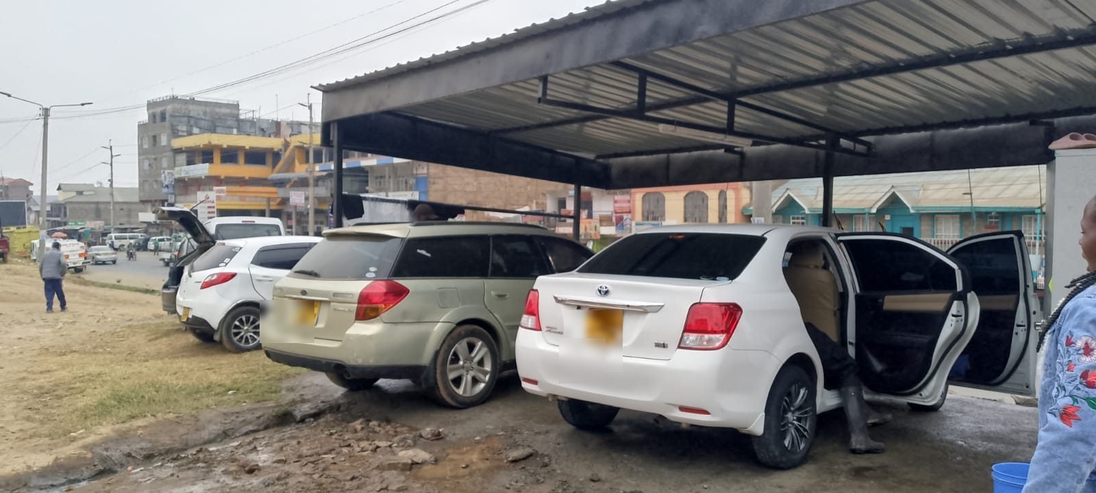 Cars being washed under the canopy